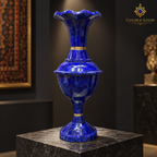 Close-up of a handcrafted lapis lazuli vase with brass collars and a scalloped rim.