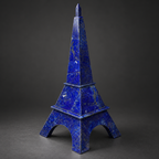 Afghan lapis lazuli Eiffel Tower sculpture showcased in a navy velvet and brass collector’s cabinet.