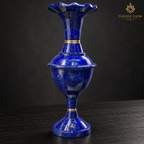 Close-up of a handcrafted lapis lazuli vase with brass collars and a scalloped rim.