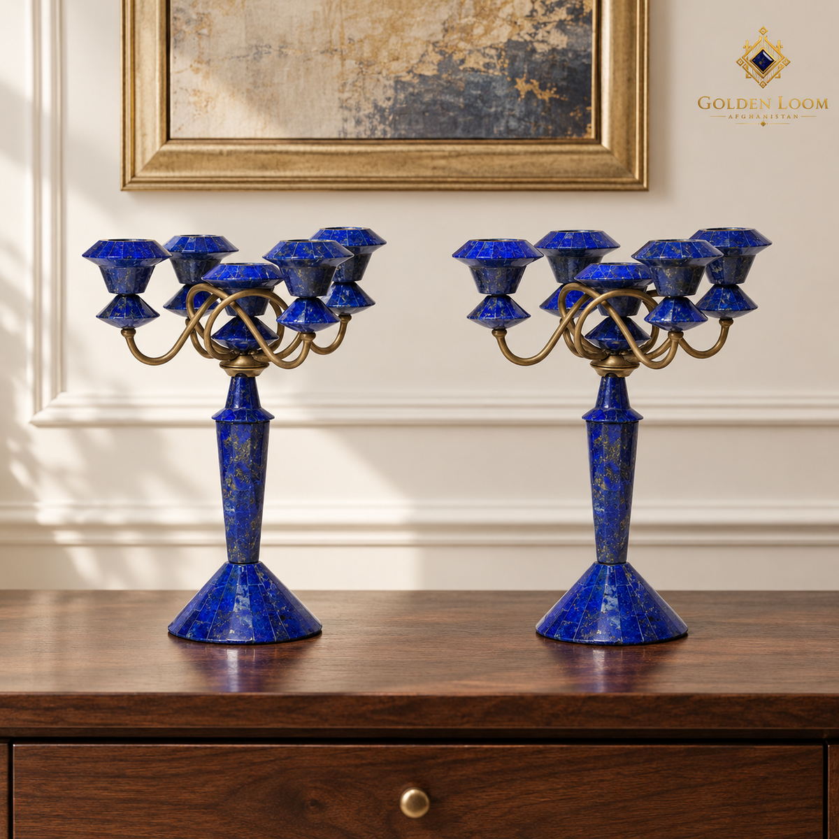 Three-quarter view of two handcrafted lapis candelabra showing five candle cups, curved brass arms and faceted stone bases