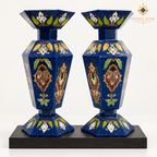 Pair of handcrafted six-sided mosaic vases with lapis lazuli chips and colorful semi-precious stone inlay on a black wooden plinth
