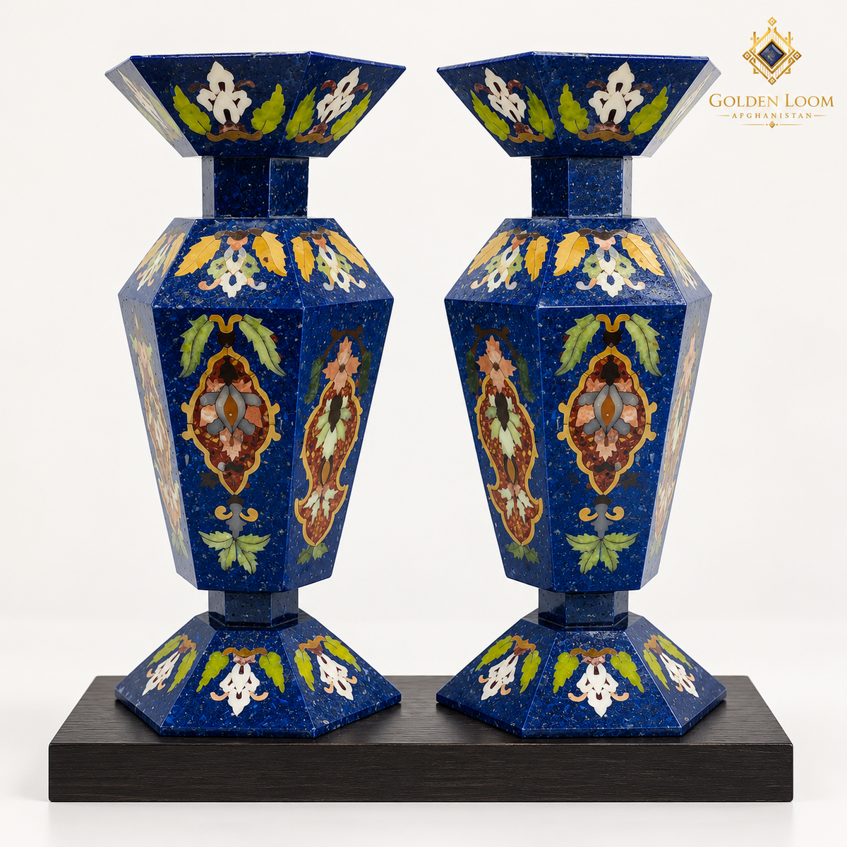 Pair of handcrafted six-sided mosaic vases with lapis lazuli chips and colorful semi-precious stone inlay on a black wooden plinth
