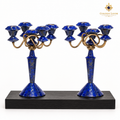 Pair of five-light lapis lazuli and brass candelabra displayed on a black wooden plinth
