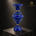 Close-up of a handcrafted Imperial lapis lazuli vase displayed on a dark stone pedestal.