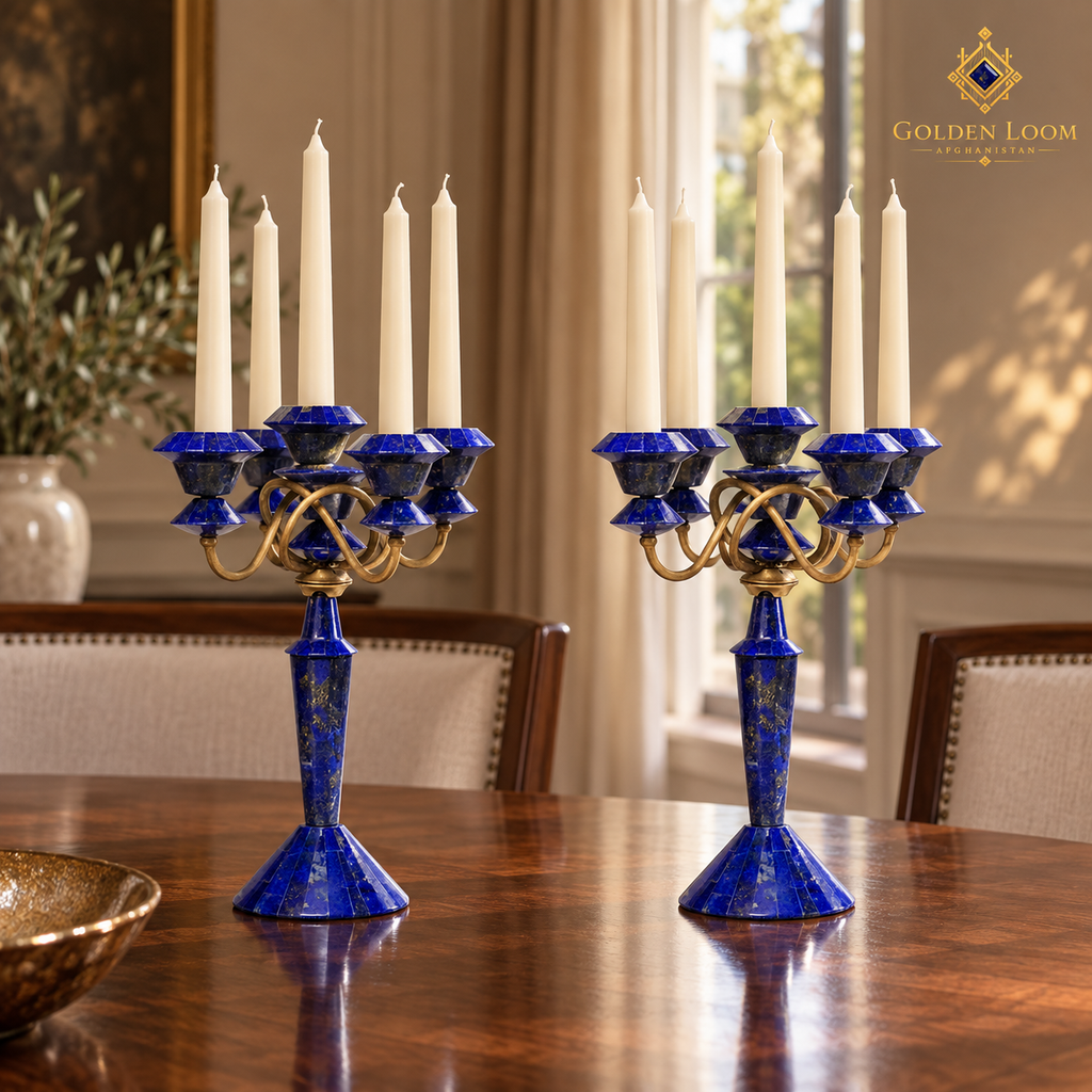 Pair of five-light lapis and brass candelabra with unlit ivory candles on an elegant walnut dining table