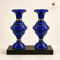 Handcrafted Imperial lapis lazuli vase pair displayed on a black wood plinth.
