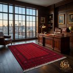 Hand-knotted Afghan Bokhara rug in deep red displayed in a luxury executive office with dark wood paneling, leather furniture, and city skyline views — Golden Loom Afghanistan