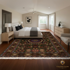 A large traditional Persian-style area rug with a central medallion and intricate floral patterns in red, green, blue, and gold tones, shown in a fully styled modern bedroom. The room features a bed, nightstands, a dresser, and a chair on dark wood floors, with the Golden Loom brand logo visible in the bottom right corner.