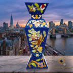 Afghan lapis lazuli painted vase with floral bird motifs on a marble ledge with Tower Bridge, the Shard, and the London skyline at sunset in the background — Golden Loom Afghanistan