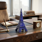 Lapis Lazuli Eiffel Tower sculpture on a luxury executive desk with leather journal and brass clock