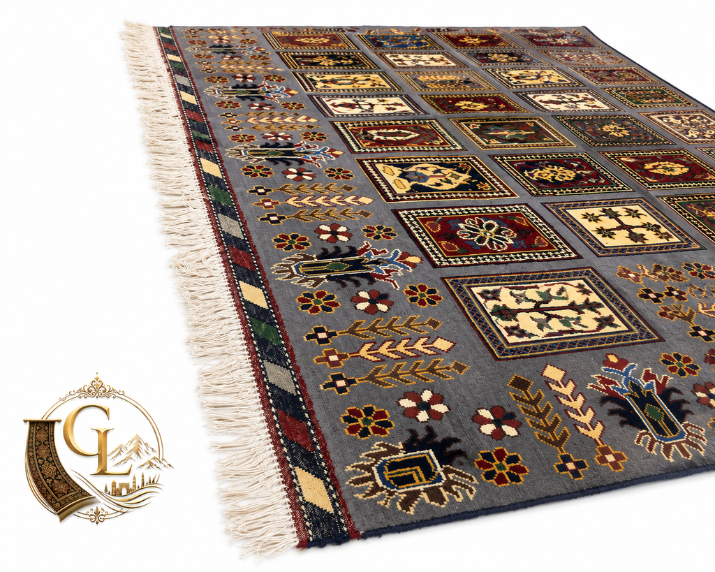 Belzhiki & Regional Mirror Design Afghan carpet – low-angle perspective view on white background showing slate-blue field with botanical panel grid, multicolored floral and cypress motifs in burgundy, ivory and gold, striped multi-color border with ivory hand-tied fringe, 202×301cm, 100% Turkman wool, hand-knotted in Qarqin, Jawzjan, Afghanistan, Golden Loom