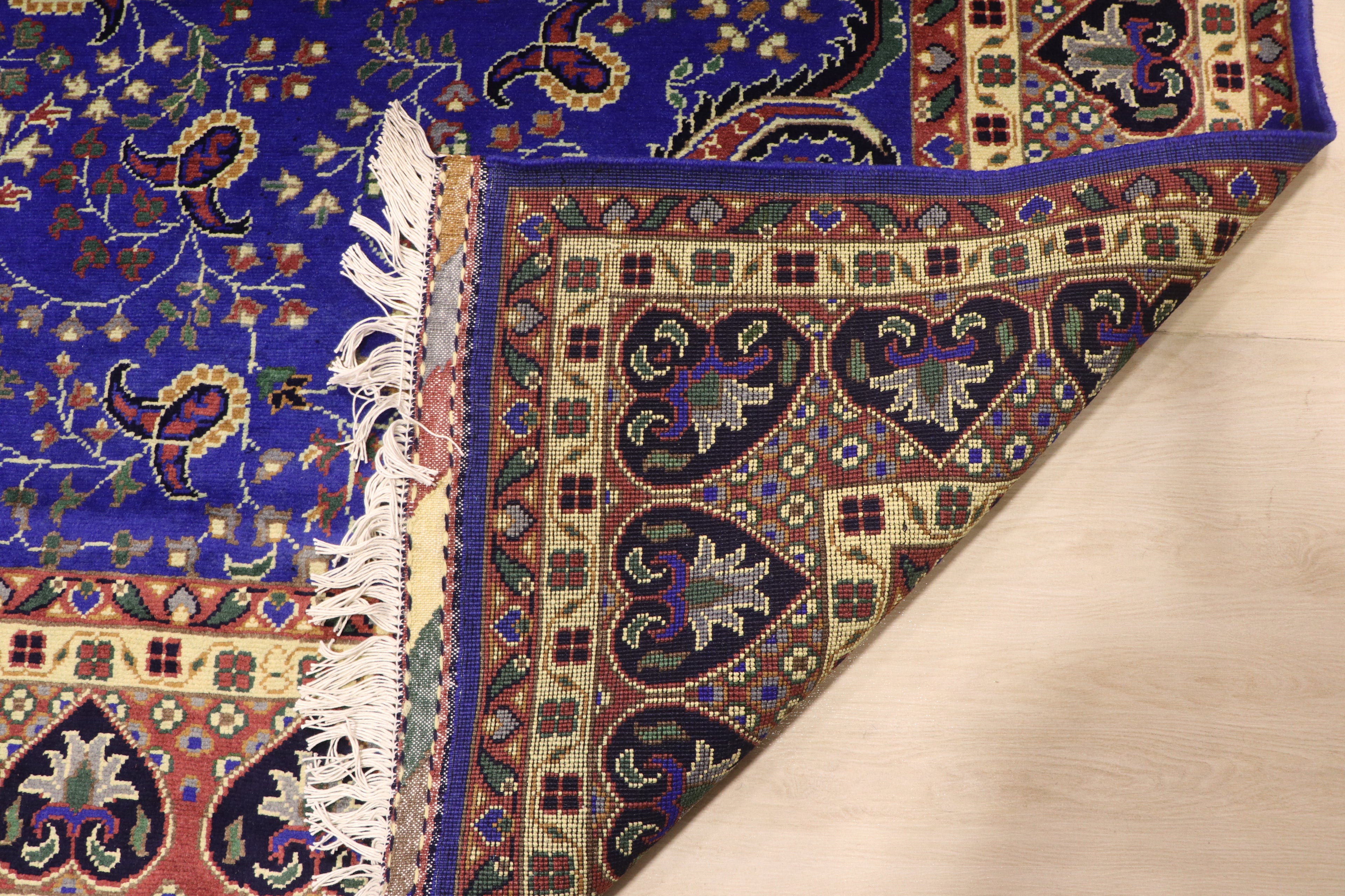 close up of backside of the carpet in illustrate the density of knots and perfectly woven