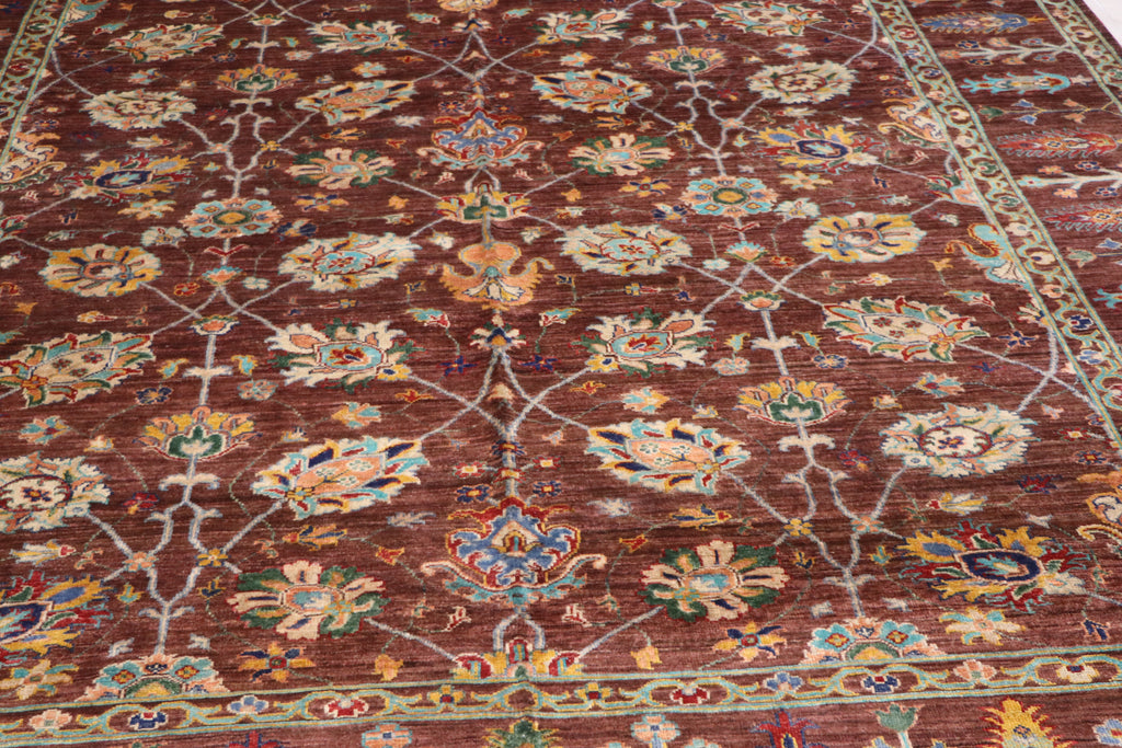 Handmade Afghan Ziegler carpet with rich brown field, multicolor floral medallions, and lattice vine pattern — close-up detail