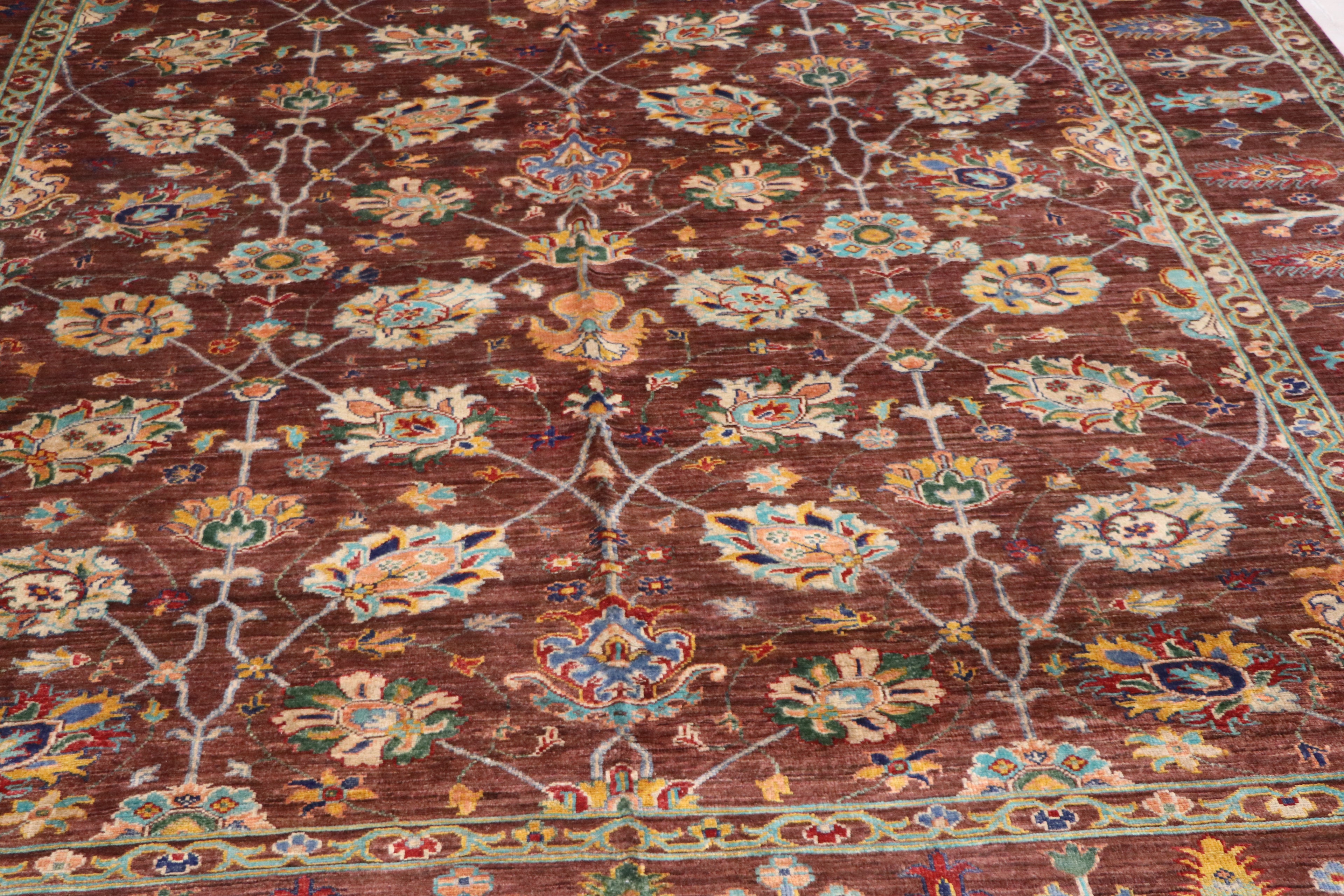 Handmade Afghan Ziegler carpet with rich brown field, multicolor floral medallions, and lattice vine pattern — close-up detail