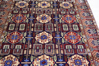 Close-up detail of Wheat Pattern Blue Afghan carpet showing floral medallions, geometric motifs, and hand-knotted wool texture, Golden Loom Afghanistan