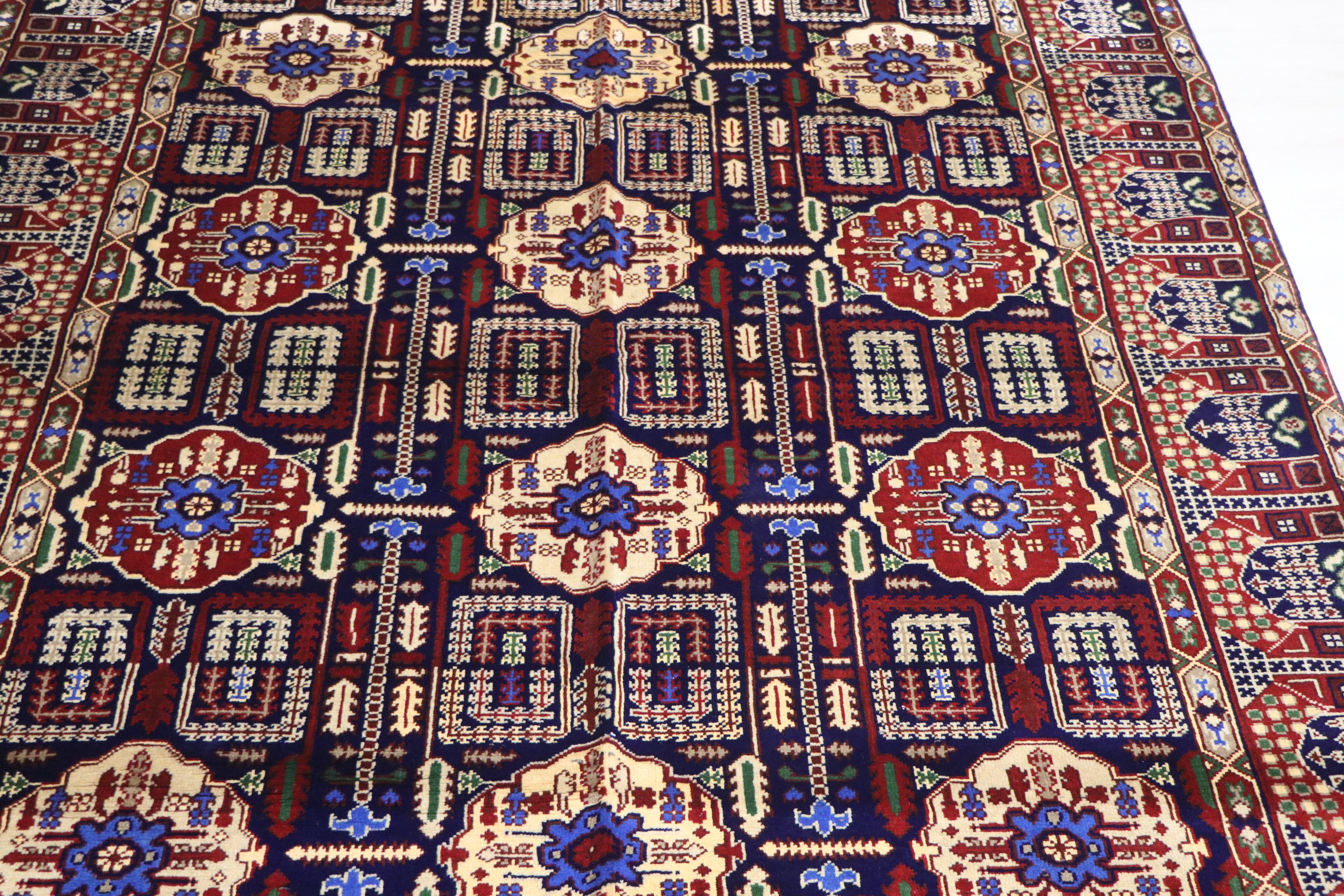 Close-up detail of Wheat Pattern Blue Afghan carpet showing floral medallions, geometric motifs, and hand-knotted wool texture, Golden Loom Afghanistan