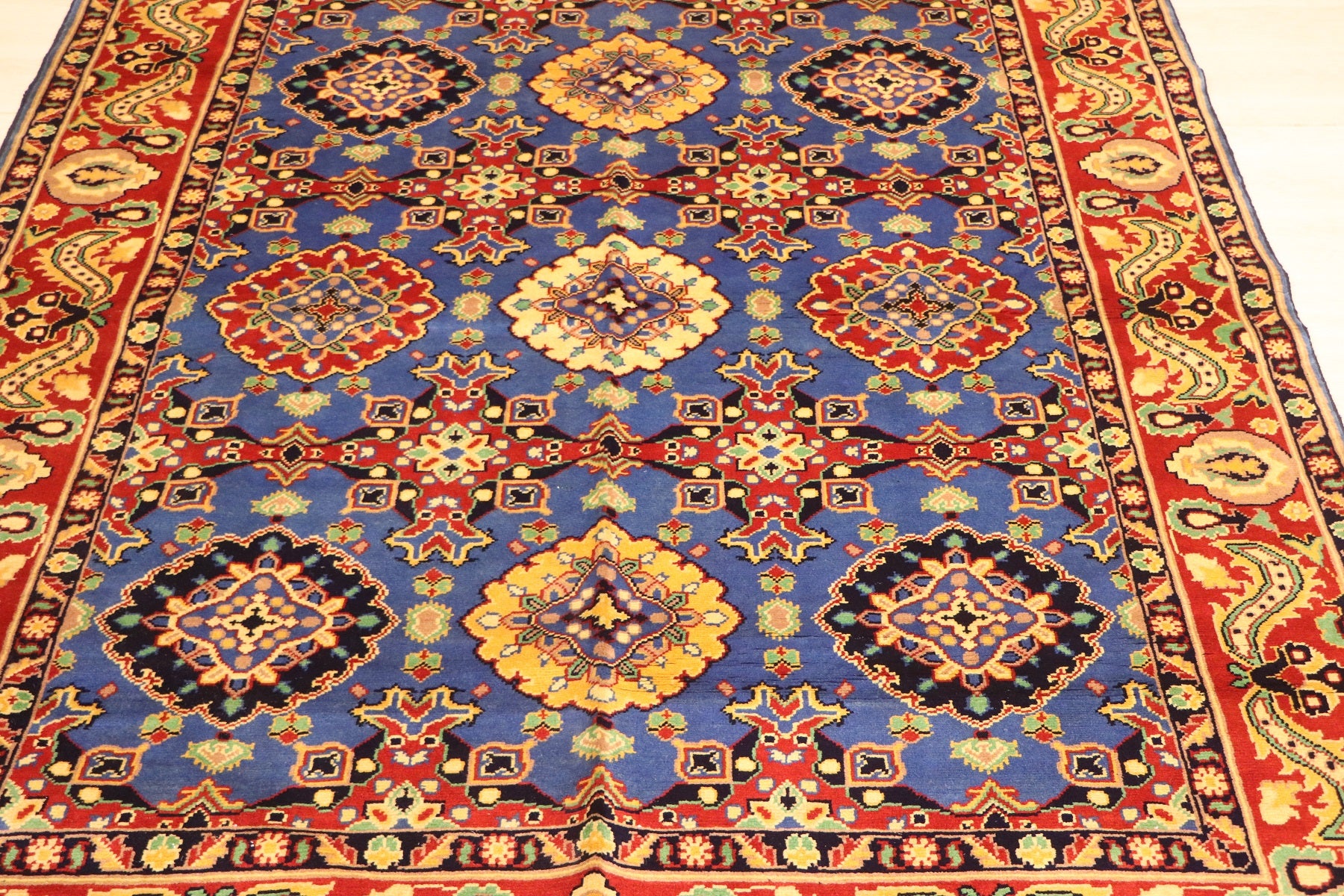 Afghan handmade Mamluk wool rug with repeating geometric medallions on royal blue field and crimson paisley border — hand-knotted in Afghanistan by Golden Loom
