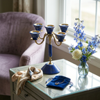 Afghan lapis lazuli 5-cup tealight candelabra on a glass side table with blue flowers, silk scarf, and jewelry pouch — Golden Loom Afghanistan