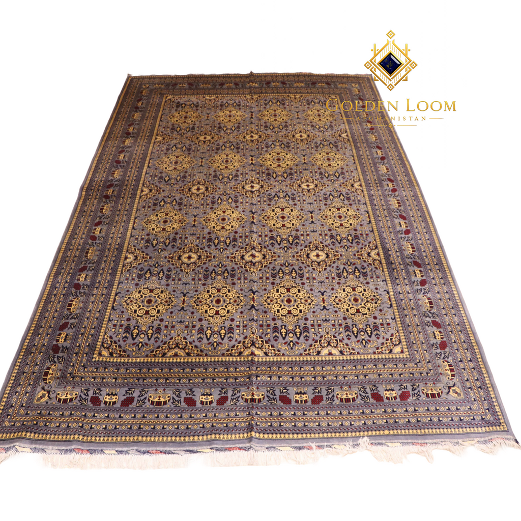 Hand-knotted Afghan carpet in slate grey with gold floral medallion pattern and ivory fringe, angled flat lay