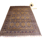 Hand-knotted Afghan carpet in slate grey with gold floral medallion pattern and ivory fringe, angled flat lay