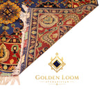 Close-up of Afghan hand-knotted Mamluk carpet corner showing dense wool pile, ivory fringe, and intricate floral border in crimson, navy, and gold — Golden Loom Afghanistan
