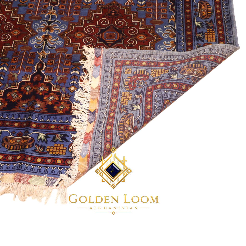 Corner fold of Afghan hand-knotted wool carpet showing tight knotted reverse and ivory fringe detail — Golden Loom Afghanistan