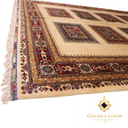 Side-angle view of Afghan hand-knotted rug highlighting intricate multi-band border with floral and geometric motifs in deep red, cobalt blue, and gold