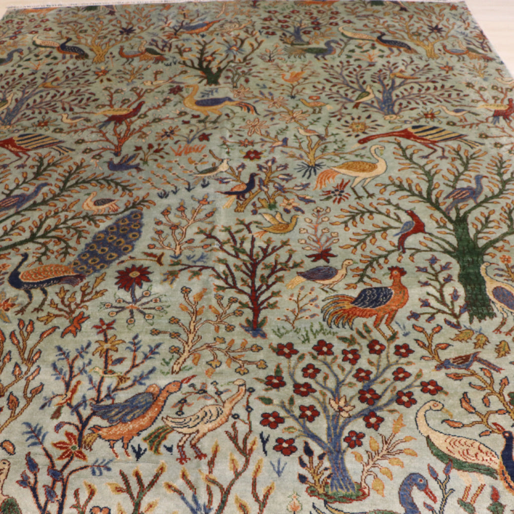 The Jawzjan Chobi Paradise Legacy highlighting its hand-knotted pattern, natural wool and artisan craftsmanship.