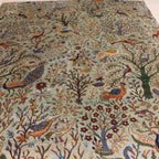 The Jawzjan Chobi Paradise Legacy highlighting its hand-knotted pattern, natural wool and artisan craftsmanship.