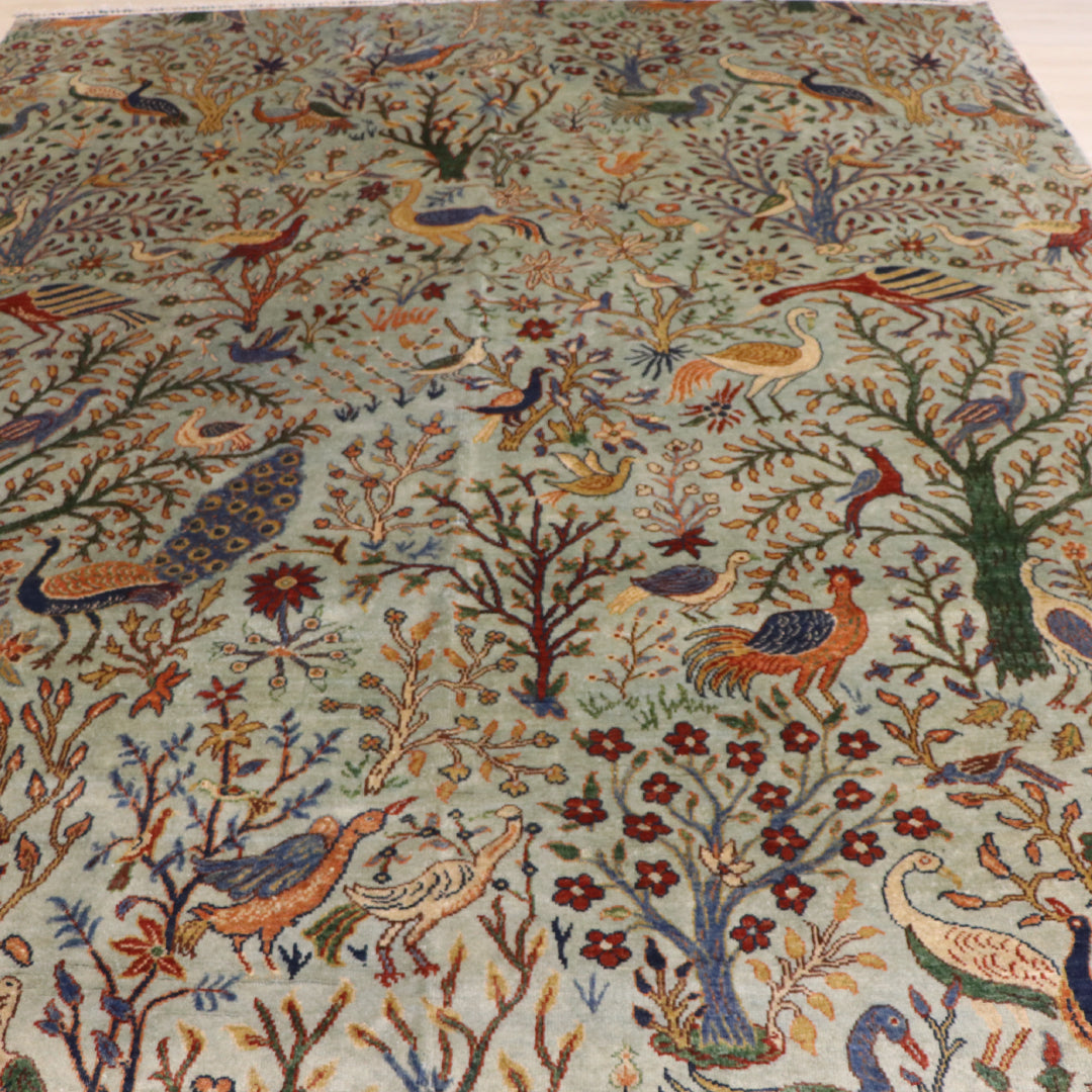The Jawzjan Chobi Paradise Legacy highlighting its hand-knotted pattern, natural wool and artisan craftsmanship.