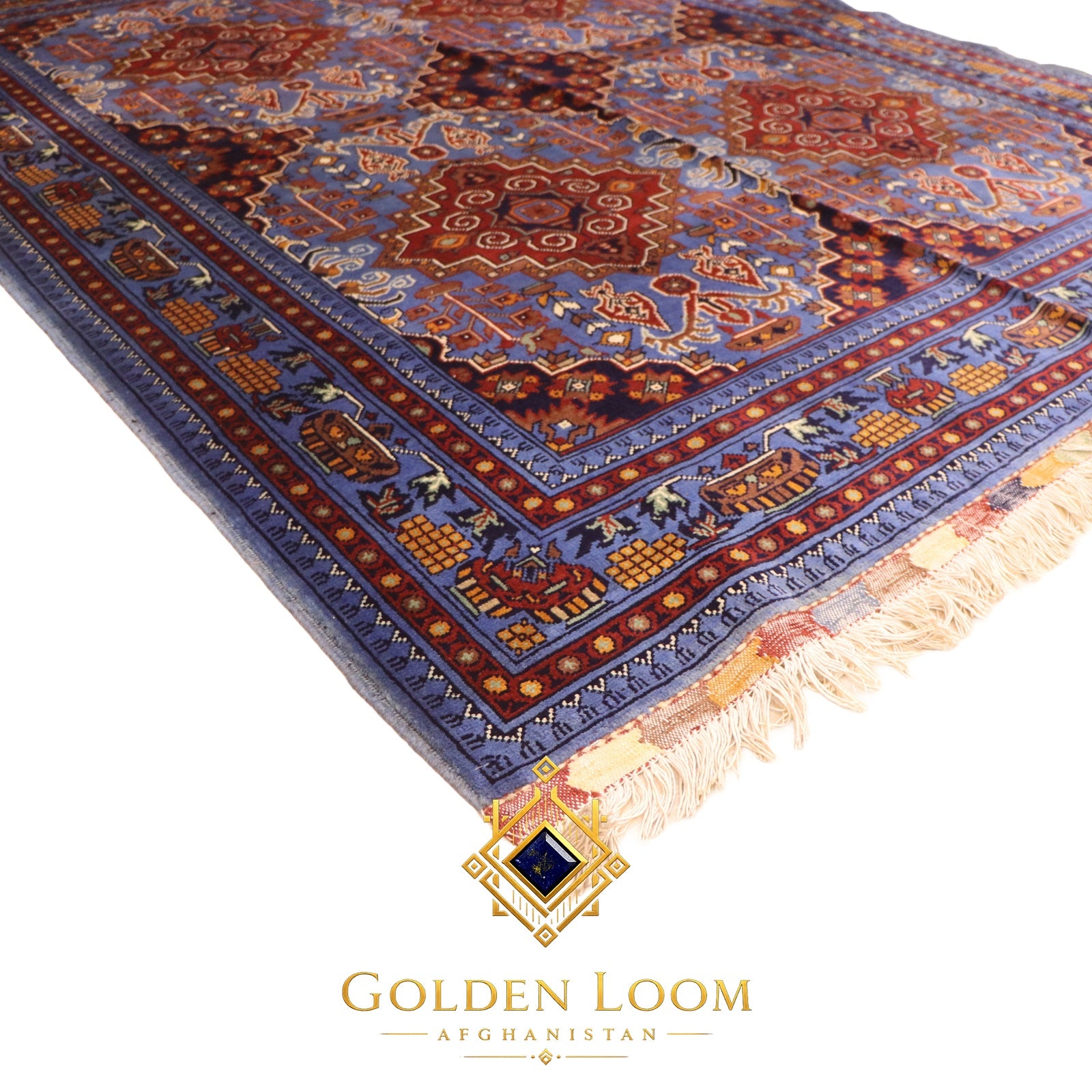 Close-up angled view of Afghan Mamluk carpet pile showing deep blue and burgundy geometric border pattern — Golden Loom Afghanistan