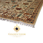 Close-up corner detail of hand-knotted Afghan Chobi rug showing ivory wool pile teal floral motifs rust botanical border and hand-tied fringe