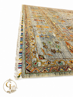 Corner detail of Chobi Sultani Diamond hand-knotted Afghan carpet showing multicolor wool fringe, geometric border in olive and crimson, and sage blue-grey pile, Golden Loom Afghanistan