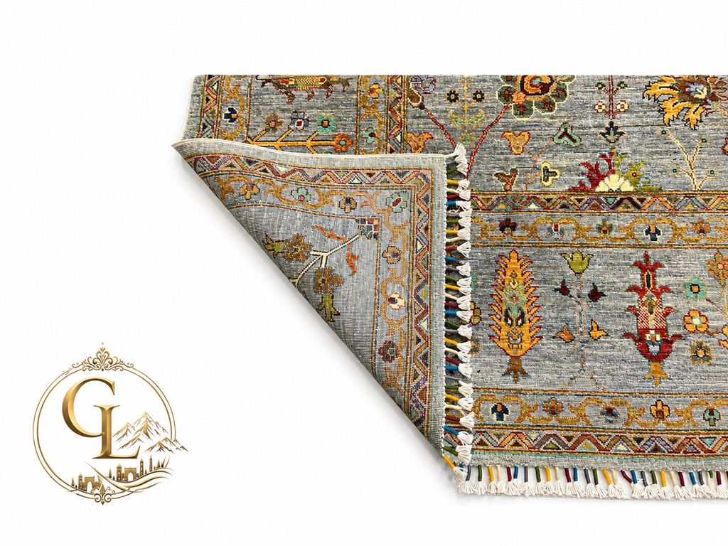 Chobi Sultani Diamond hand-knotted Afghan carpet with corner folded to reveal cotton back and tight knot structure, sage blue-grey pile with saffron cypress tree and botanical motifs, multicolor wool fringe, Golden Loom Afghanistan