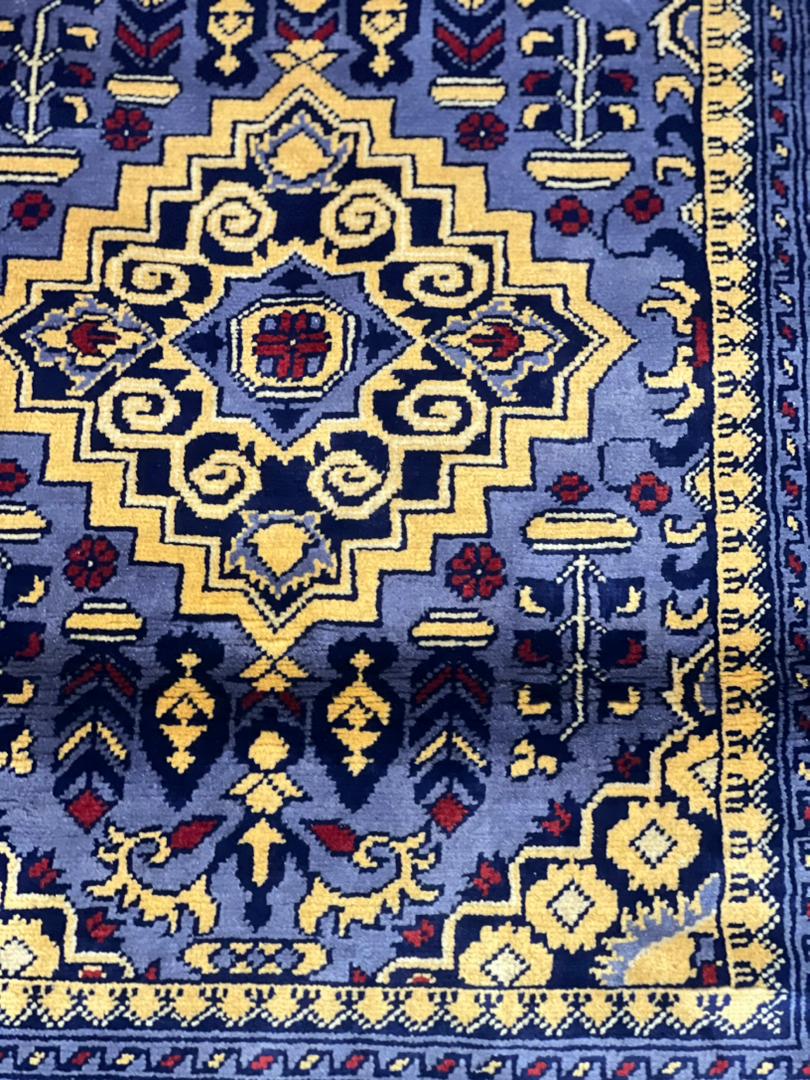 Detailed close-up of ZerKhaki geometric medallion on Belzhiki handmade Afghan carpet – blue and gold cut pile wool rug woven by master artisans in Jawzjan, Afghanistan