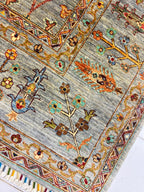 Close-up of Chobi Sultani Diamond carpet pile showing hand-knotted floral and botanical motifs in saffron, teal, crimson and olive on sage grey wool, Jawzjan Afghanistan