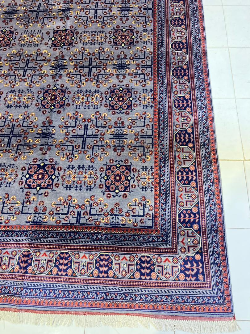 Detail shot of Afghan Bokhara rug showing silver grey field and coral red border – 100% natural wool