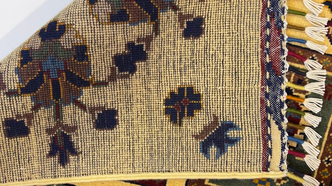 Detail shot of Afghan Chobi rug displaying tribal motifs and burgundy panel borders – 100% natural Turkman wool