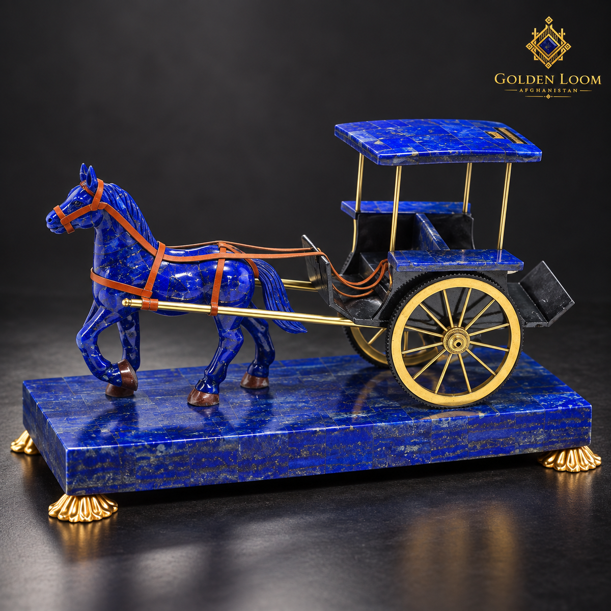 Side view of the handcrafted lapis lazuli horse carriage showing its harness, canopy and brass wheels.
