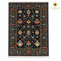 Top view of black hand-knotted Afghan wool carpet with colourful floral motifs, fringed ends and Golden Loom Afghanistan logo
